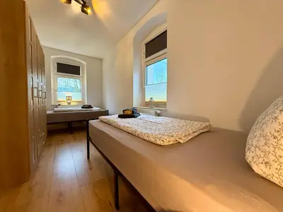 Ein Bett oder Betten in einem Zimmer der Unterkunft Wohnperle Sporbitzer Stübchen 2