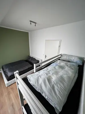 Ein Bett oder Betten in einem Zimmer der Unterkunft Ferienwohnung zum Scheibe-See