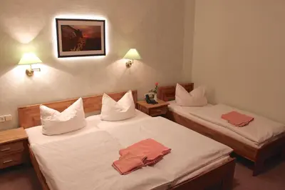 Ein Bett oder Betten in einem Zimmer der Unterkunft Gasthof Hertigswalde