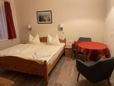Ein Bett oder Betten in einem Zimmer der Unterkunft Gasthof Hertigswalde