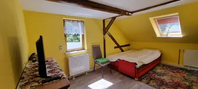 Ein Bett oder Betten in einem Zimmer der Unterkunft Ferienwohnung am Fuße des Schwartenberges