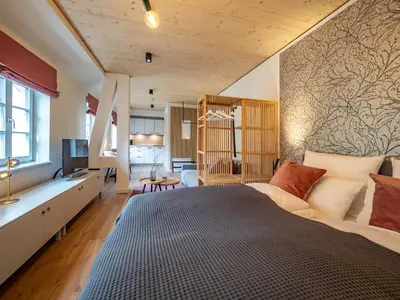 Ein Bett oder Betten in einem Zimmer der Unterkunft Alte Bäckerei Königstein Aparthotel und Café