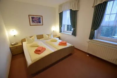 Ein Bett oder Betten in einem Zimmer der Unterkunft Wolfsgrunder Festhof