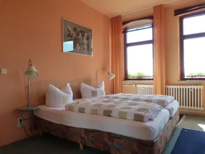 Ein Bett oder Betten in einem Zimmer der Unterkunft Waldhaus Colditz Garni