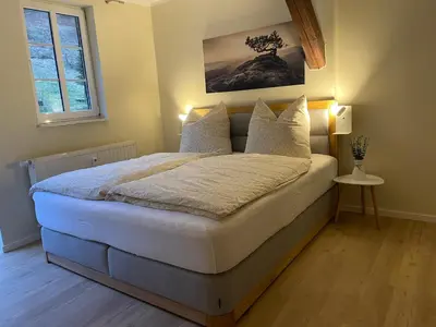 Ein Bett oder Betten in einem Zimmer der Unterkunft Ferienwohnung Kohlbornsteinblick am Malerweg