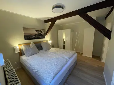 Ein Bett oder Betten in einem Zimmer der Unterkunft Ferienwohnung Kohlbornsteinblick am Malerweg