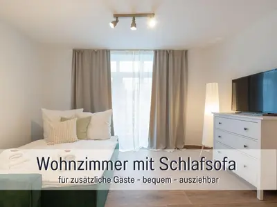Ein Bett oder Betten in einem Zimmer der Unterkunft Benville BV08 - helle 92 qm Fewo in Villa - ruhige Lage - Großer Garten & ÖPNV fußläufig