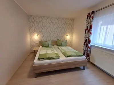 Ein Bett oder Betten in einem Zimmer der Unterkunft Haus Falkensteinblick
