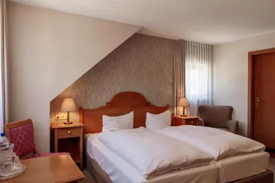 Ein Bett oder Betten in einem Zimmer der Unterkunft Hotel Ettrich & Elbresort Rathen
