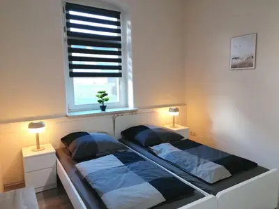 Ein Bett oder Betten in einem Zimmer der Unterkunft Ferienwohnung und Zimmervermietung Zur Alten Post