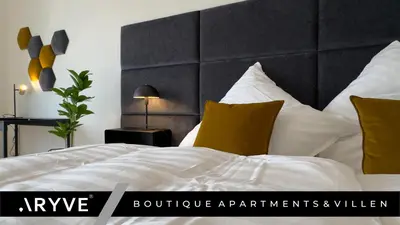 Ein Bett oder Betten in einem Zimmer der Unterkunft ARYVE Boutique-Apartment DRESDNER PENTHOUSE mit Dachterrasse - Tiefgaragenstellplätze - Design-Interieur