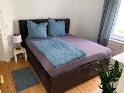 Ein Bett oder Betten in einem Zimmer der Unterkunft Ferienwohnung am Tivoli