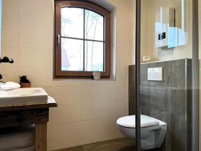 Ein Badezimmer in der Unterkunft Ferienhäuser KRABAT-Mühle Schwarzkollm