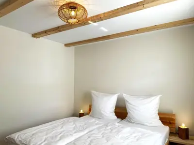 Ein Bett oder Betten in einem Zimmer der Unterkunft Ferienhäuser KRABAT-Mühle Schwarzkollm