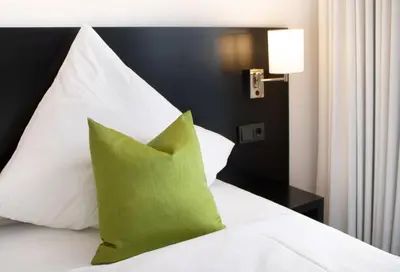 Ein Bett oder Betten in einem Zimmer der Unterkunft FG Hotel by WMM Hotels