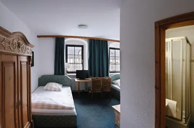 Ein Bett oder Betten in einem Zimmer der Unterkunft Braugut Hartmannsdorf