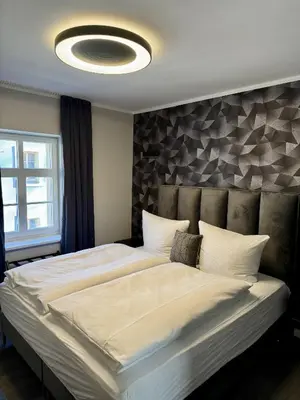 Ein Bett oder Betten in einem Zimmer der Unterkunft Apartmenthaus Burkhardt