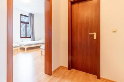 Ein Bett oder Betten in einem Zimmer der Unterkunft Perfekt für Gruppen mit Waschmaschine, Einzelbetten, Küche