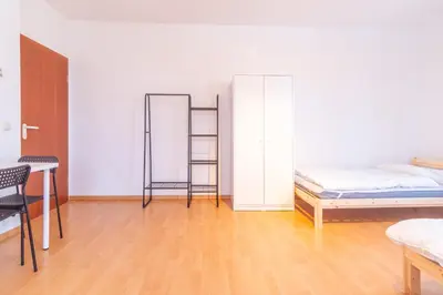 Ein Bett oder Betten in einem Zimmer der Unterkunft Perfekt für Gruppen mit Waschmaschine, Einzelbetten, Küche