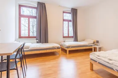 Ein Bett oder Betten in einem Zimmer der Unterkunft Perfekt für Gruppen mit Waschmaschine, Einzelbetten, Küche