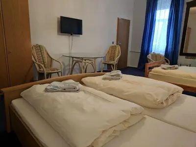 Ein Bett oder Betten in einem Zimmer der Unterkunft Bahnhotel Dippoldiswalde