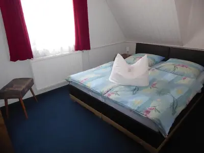 Ein Bett oder Betten in einem Zimmer der Unterkunft Ferienwohnung Rumrich