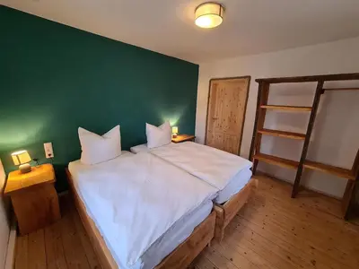 Ein Bett oder Betten in einem Zimmer der Unterkunft 24 Personen Ferienhaus Burgscheune Gnandstein