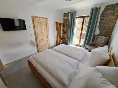 Ein Bett oder Betten in einem Zimmer der Unterkunft 24 Personen Ferienhaus Burgscheune Gnandstein