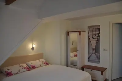 Ein Bett oder Betten in einem Zimmer der Unterkunft Pension AM REICHEN BERG