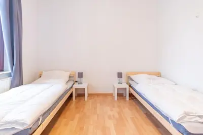 Ein Bett oder Betten in einem Zimmer der Unterkunft Einzelbetten, Waschmaschine, ideal für Gruppen