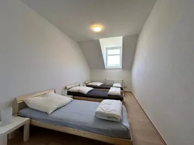 Ein Bett oder Betten in einem Zimmer der Unterkunft Einzelbetten, Waschmaschine, ideal für Gruppen