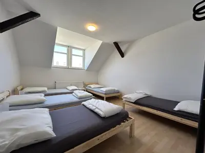 Ein Bett oder Betten in einem Zimmer der Unterkunft Einzelbetten, Waschmaschine, ideal für Gruppen