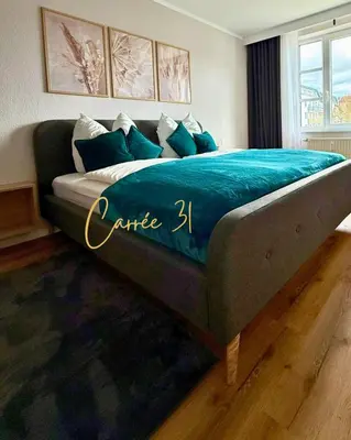 Ein Bett oder Betten in einem Zimmer der Unterkunft Carrée 31 Balkon, Privatparkplatz, Aufzug, Kaffee