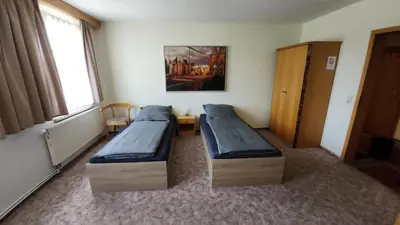 Ein Bett oder Betten in einem Zimmer der Unterkunft Pension 7-Eichen 44