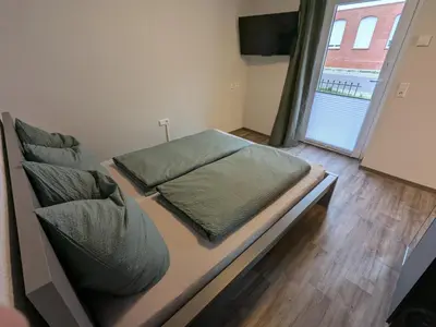 Ein Bett oder Betten in einem Zimmer der Unterkunft Ferienwohnung Sydom
