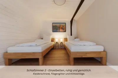 Ein Bett oder Betten in einem Zimmer der Unterkunft CASA BENJI - Familienfreundliche FeWo - Landhausstil - Garten - Parkplatz