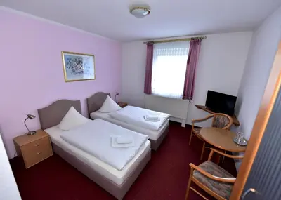 Ein Bett oder Betten in einem Zimmer der Unterkunft Pension Schwesinger