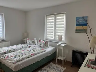 Ein Bett oder Betten in einem Zimmer der Unterkunft Ferienwohnung an der Rosenstraße