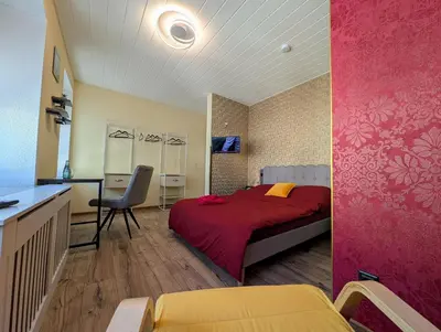 Ein Bett oder Betten in einem Zimmer der Unterkunft Komfortzimmer Waldheim