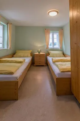 Ein Bett oder Betten in einem Zimmer der Unterkunft Ferienhaus Herta ein charmant, saniertes Einzeldenkmal im Elbsandsteingebirge -Nähe Bad Schandau