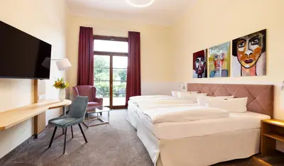 Ein Bett oder Betten in einem Zimmer der Unterkunft Kim Schlosshotel im Park