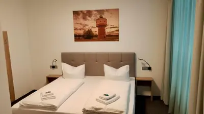 Ein Bett oder Betten in einem Zimmer der Unterkunft DH Hotel Deutsches Haus Mittweida - Ihr digitales Hotel