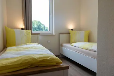 Ein Bett oder Betten in einem Zimmer der Unterkunft Ferienwohnungen im Waldhaus Sebnitz