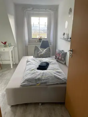 Ein Bett oder Betten in einem Zimmer der Unterkunft Ferienwohnung Maria mit Elbblick