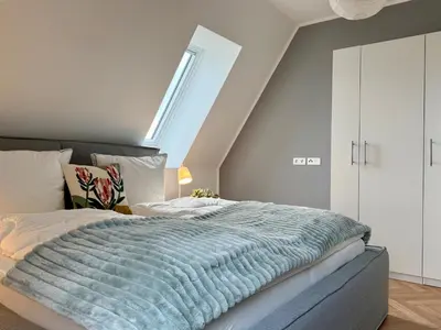 Ein Bett oder Betten in einem Zimmer der Unterkunft Neu!! Ruhige helle Penthouse Wohnung - Parking incl