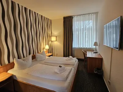 Ein Bett oder Betten in einem Zimmer der Unterkunft Parkhotel Senftenberg