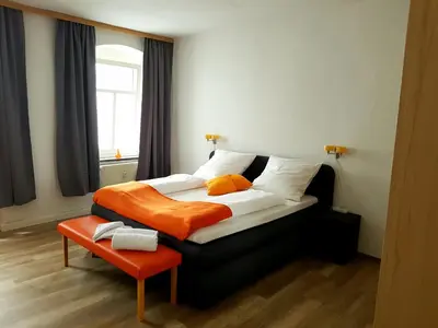 Ein Bett oder Betten in einem Zimmer der Unterkunft Ferienwohnung 1 Christiansdorf Freiberg