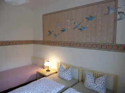 Ein Bett oder Betten in einem Zimmer der Unterkunft 3R Fewo bis 9 Personen zentral T4