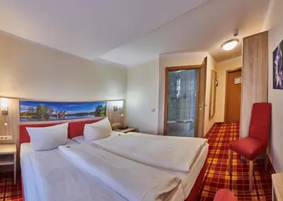 Ein Bett oder Betten in einem Zimmer der Unterkunft Hotel Elbparadies