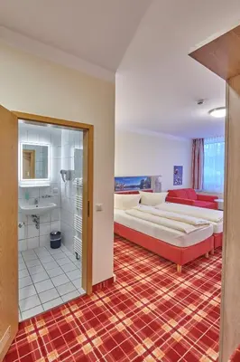 Ein Bett oder Betten in einem Zimmer der Unterkunft Hotel Elbparadies
